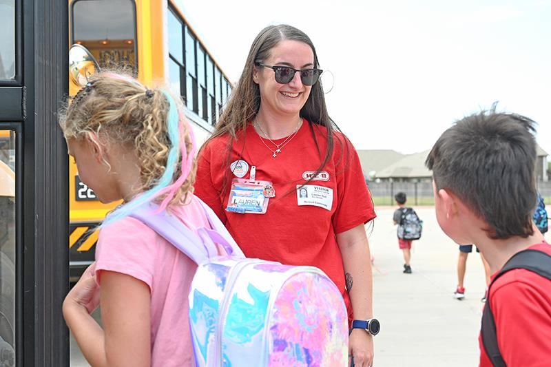 Lauren Rud with H-E-B on Tuckerton welcomes students to their bus at Rennell Elementary School on Aug. 28. 